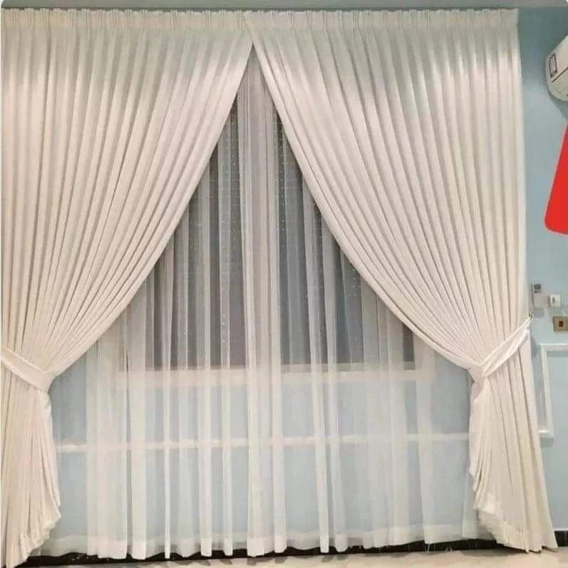 Even S-fold wave curtain on a ceiling track in Doha