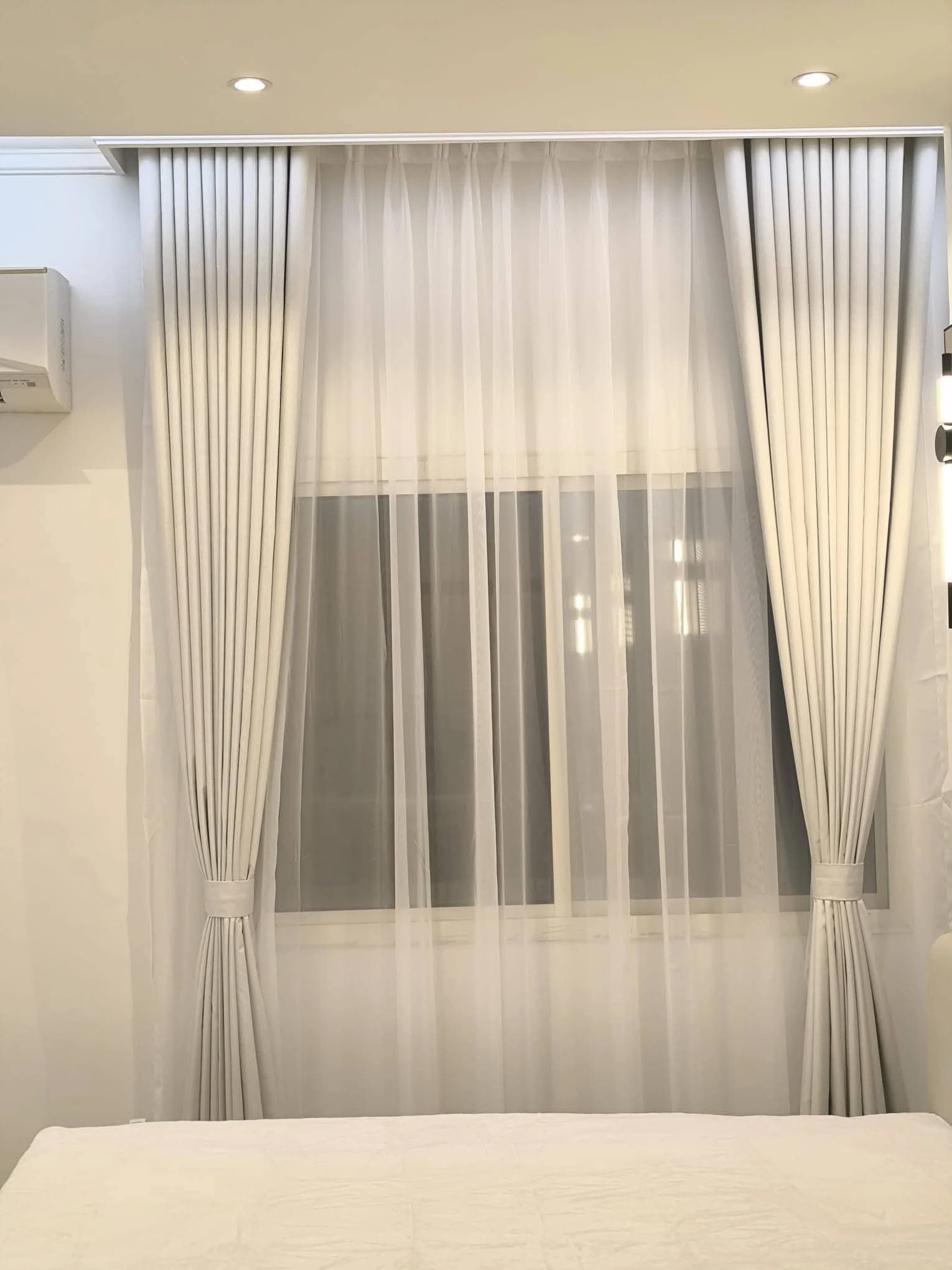 Floor to ceiling wave curtains fitted in a Doha apartment by Doha Home Fix